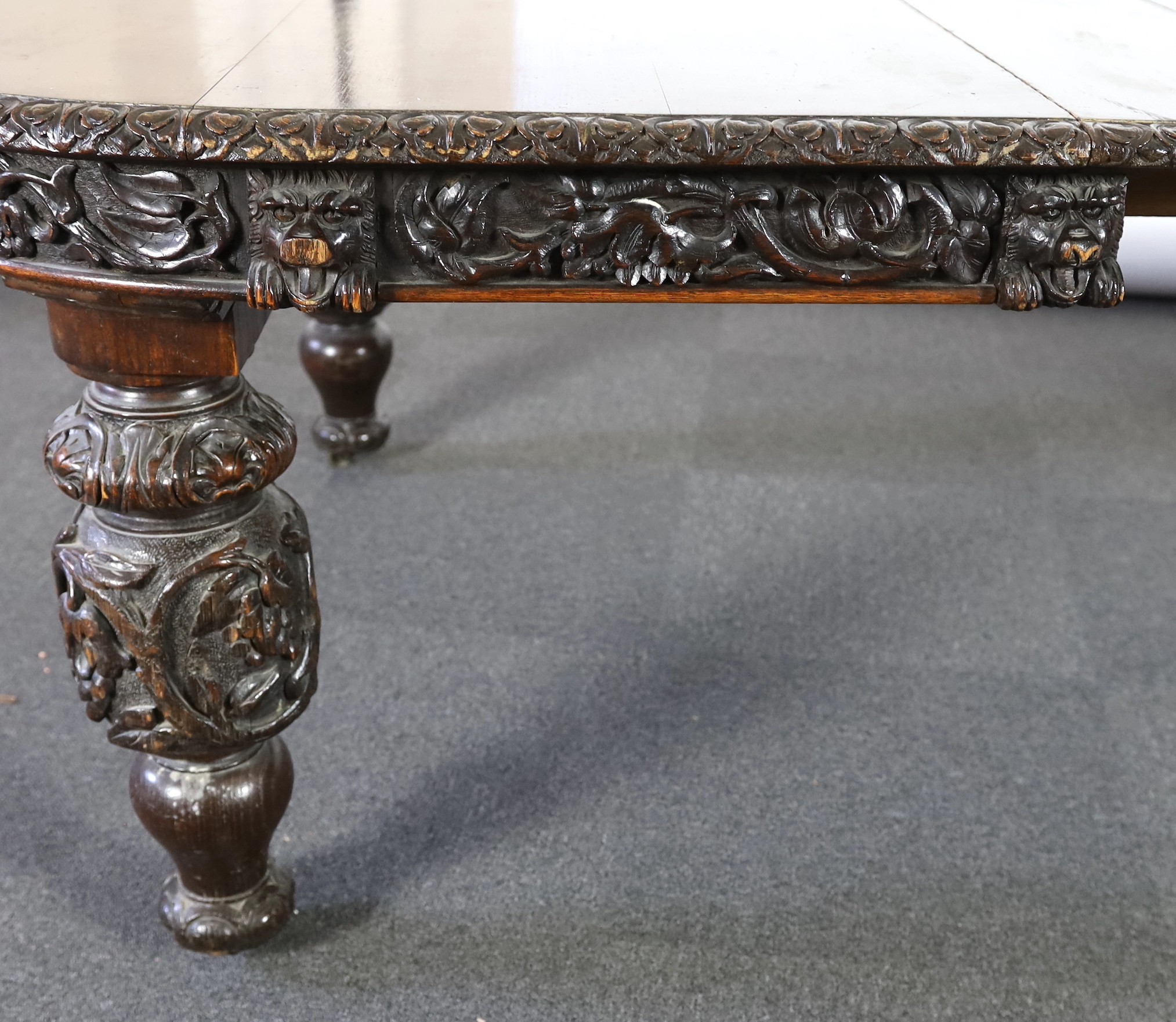 A late Victorian carved oak extending dining table, 178 x 142cm, extends to 356cm H.75cm